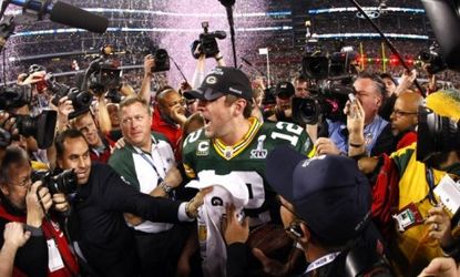 Green Bay Packers quarterback Aaron Rodgers celebrates a Super Bowl win Sunday -- as a labor dispute looms between NFL players and owners.