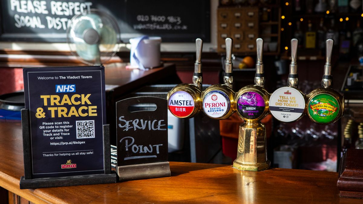 A Test and Trace sign next to beer pumps in a hospitality venue