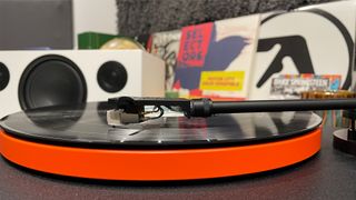 JBL Spinner BT turntable from side angle playing record