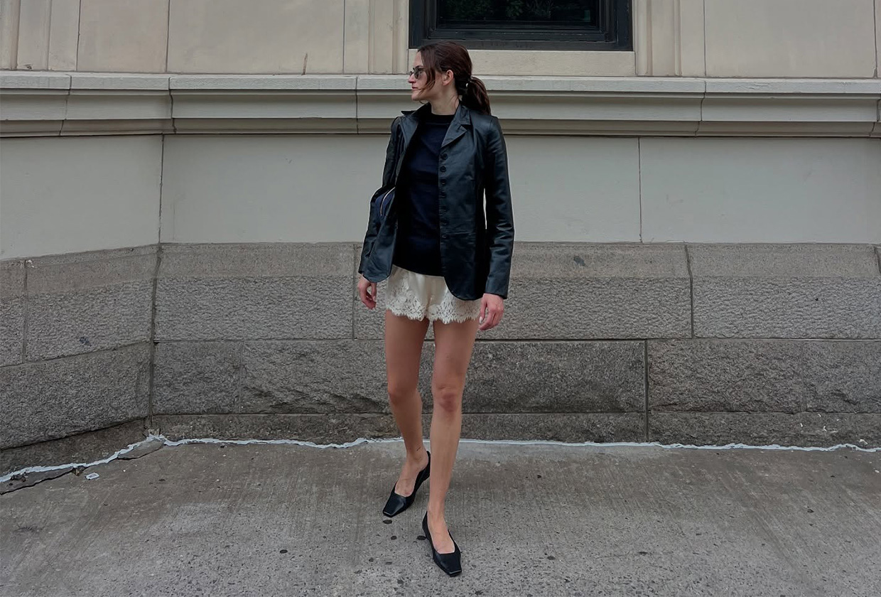Eliza Huber wearing a leather blazer, lace shorts, and flats.