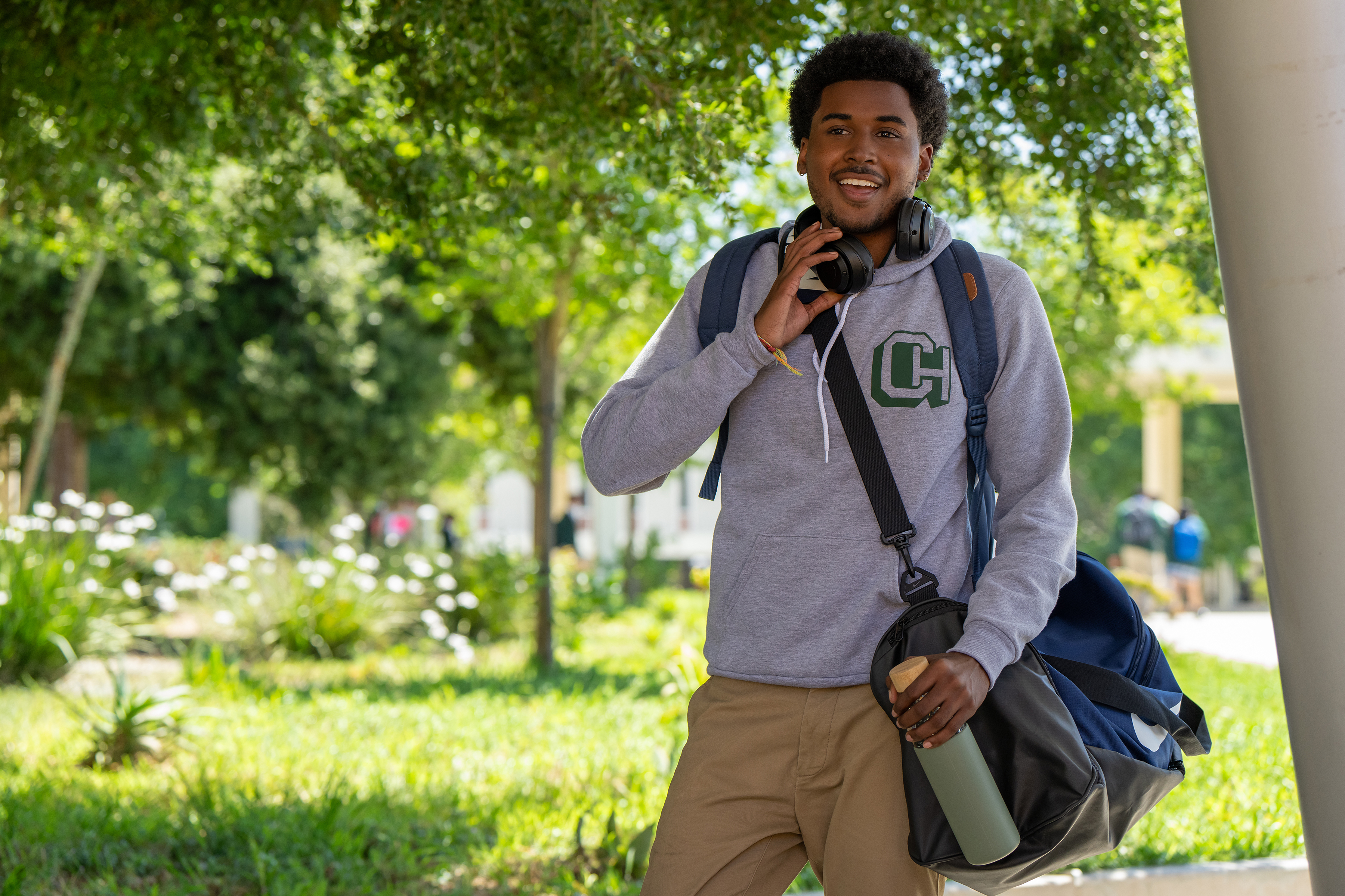 michael cooper jr as justin edwards wearing. a sweatshirt and headphones and walking to school in the tv show forever