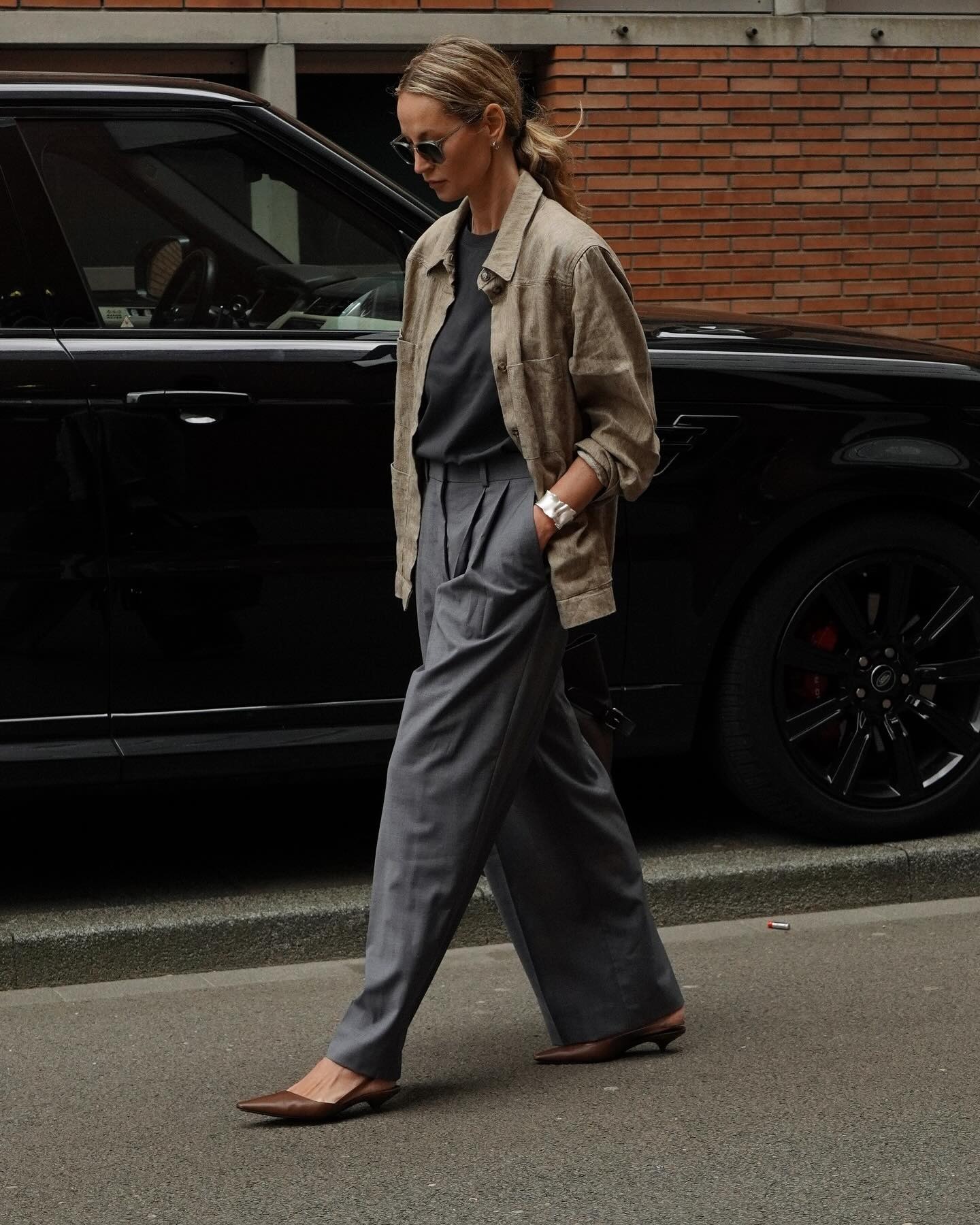 Woman in brown pumps and gray trousers