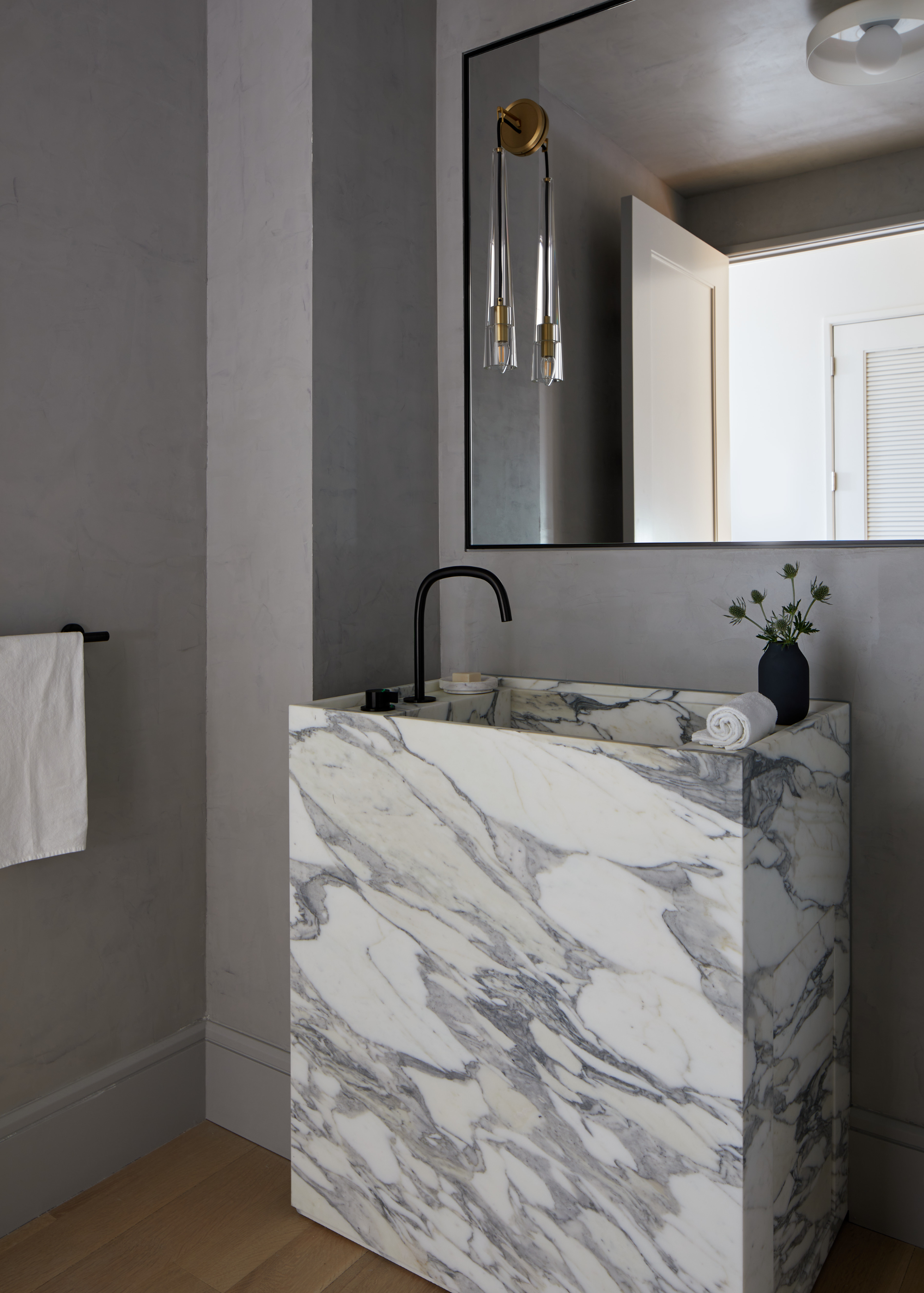 A bathroom with a veined marble sink