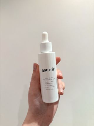 Mica Ricketts holding Nourrir Root Cause Nourishing Serum