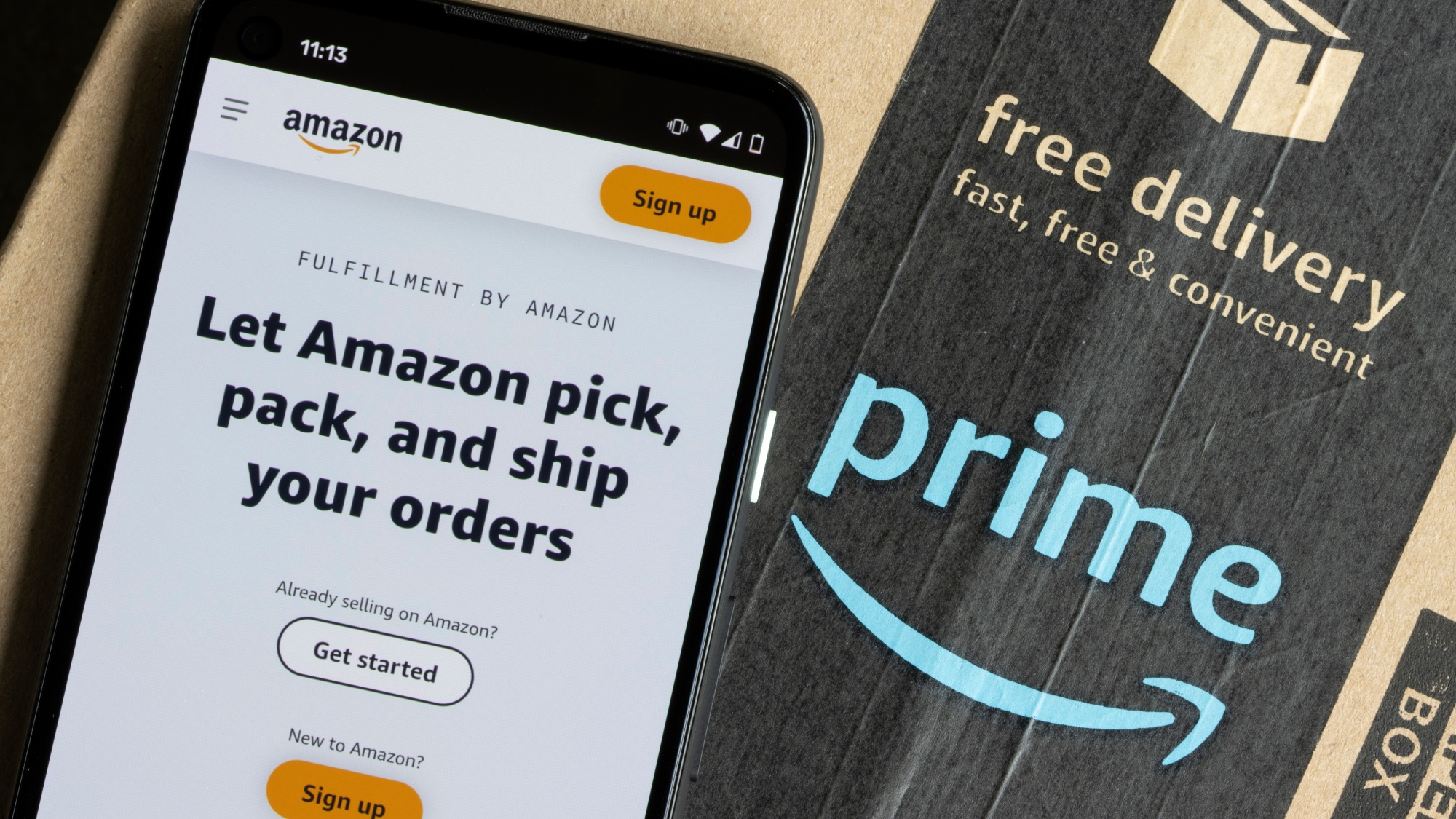 Amazon on phone next to Prime box 