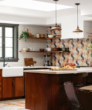 A dark wood kitchen with colorful patterned tiles