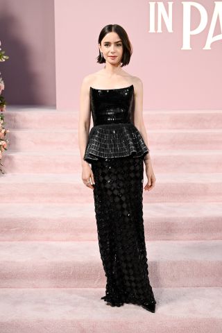 Lily Collins wearing a custom black Armani Privé gown to the 'Emily in Paris' Los Angeles premiere August 2024