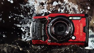 Image of Olympus Tough TG-6 outdoors being splashed with water