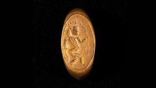 This gold ring shows an engraving of Bes, the ancient Egypt god of fun, depicted as a dwarf.