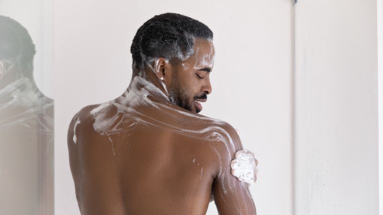 Man using a body wash in the shower