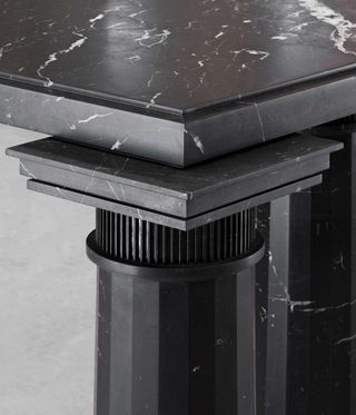 Close-up of black marble worktop and supporting pillar