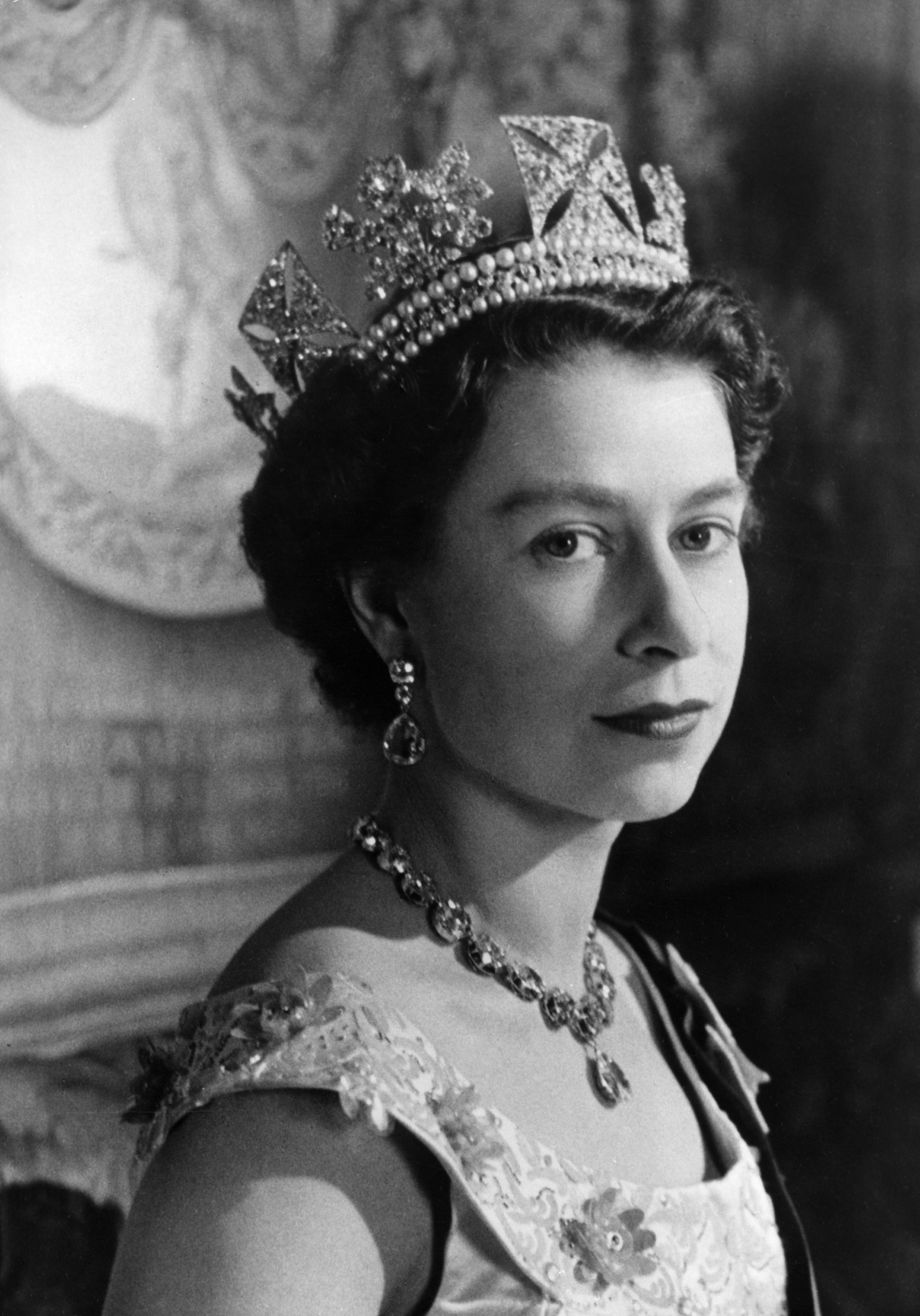 A side view of Queen Elizabeth wearing a tiara and diamond necklace