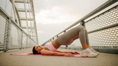 A woman performing a glute bridge