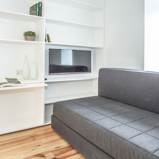 living room with tv white wall and wooden floor