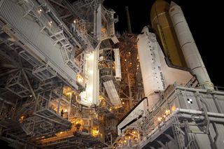 The rotating service structure, which provides weather protection and access to the shuttle, moves into place around space shuttle Discovery on Launch Pad 39A at NASA's Kennedy Space Center in Florida. 