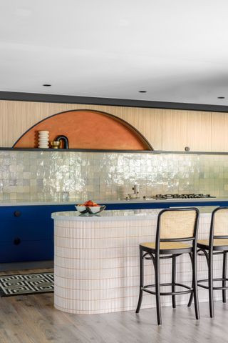 a modern kitchen with a tiled island