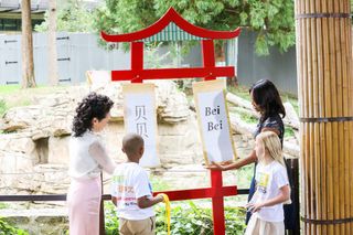 Third-grade students from the Washington Yu Ying Public Charter School helped the first ladies by unfurling the scrolls to reveal the cub's name, Bei Bei.