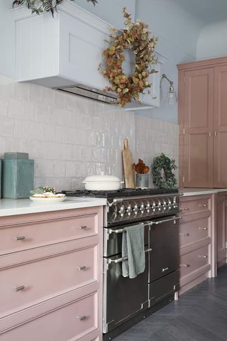 pink kitchen cabinets with molding details
