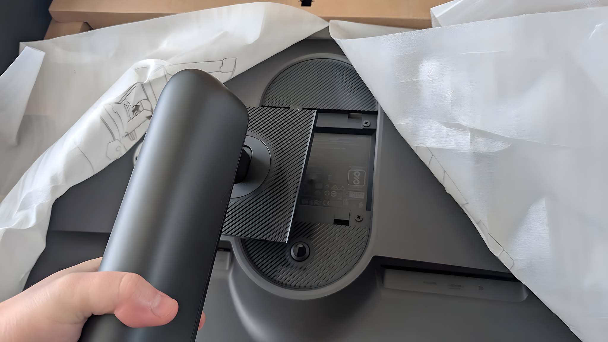 Image showing the stand right before it's pressed into the back of the Alienware AW2725QF Gaming Monitor.