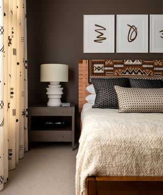 bedroom with dark brown walls and neutral bedding