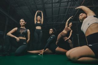 A group of gymgoers stretching whilst wearing their Forme sportswear