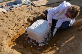 Researchers excavated the dagger and other artifacts in a large earthen block.