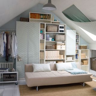 Attic room with built in storage and sofa bed