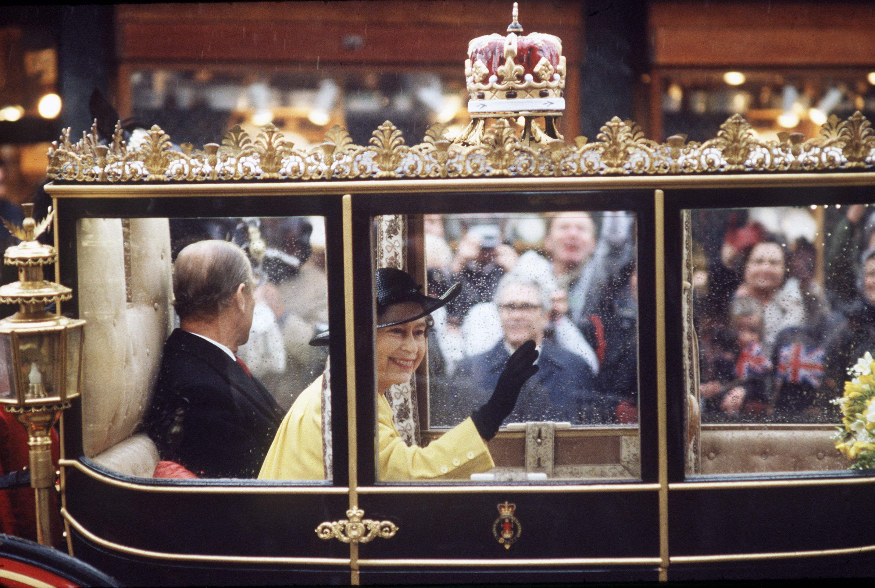 Queen Elizabeth waving from a glass coach on her 60th birthday