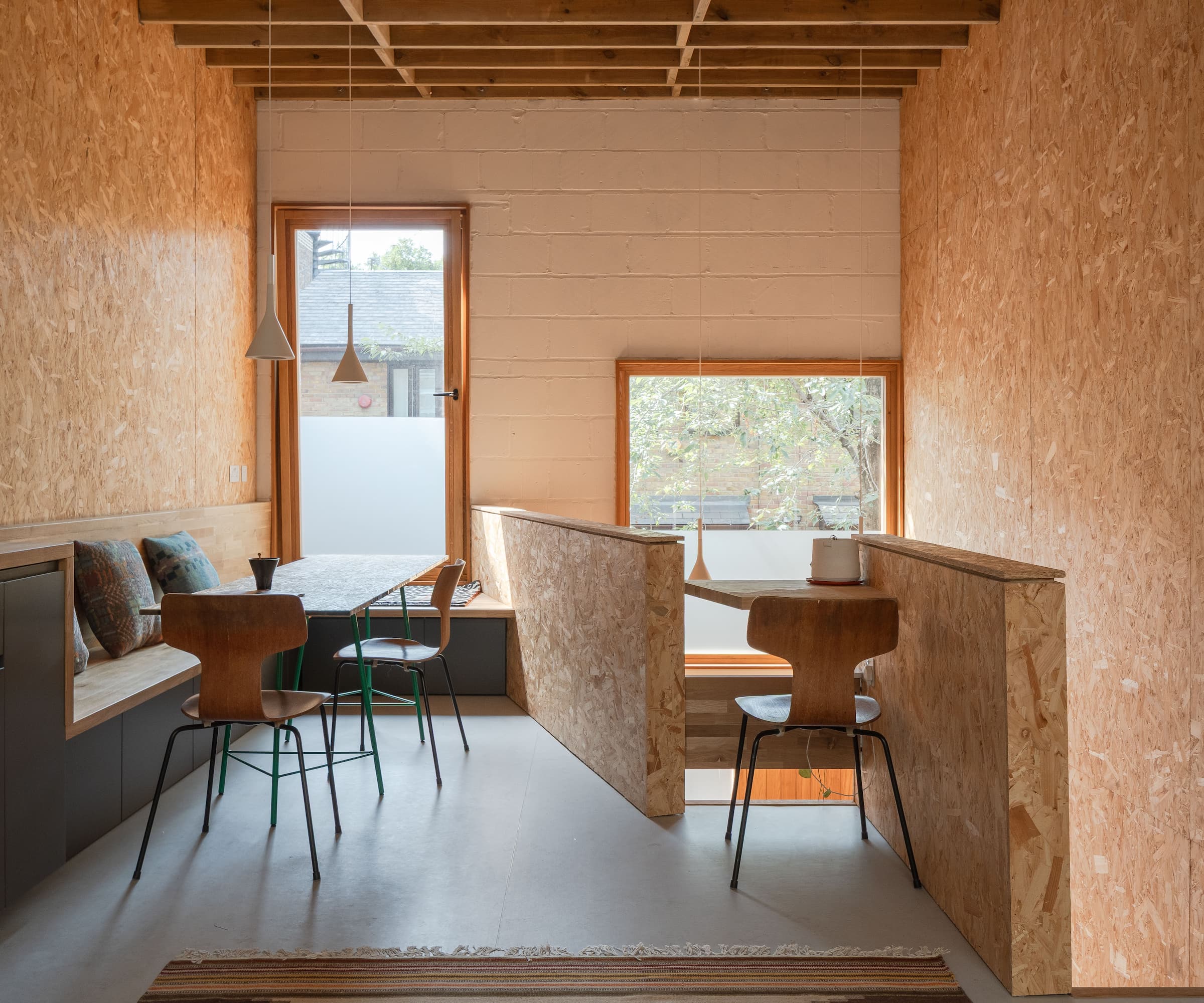 A office and dining space upstairs with plasterboard walls