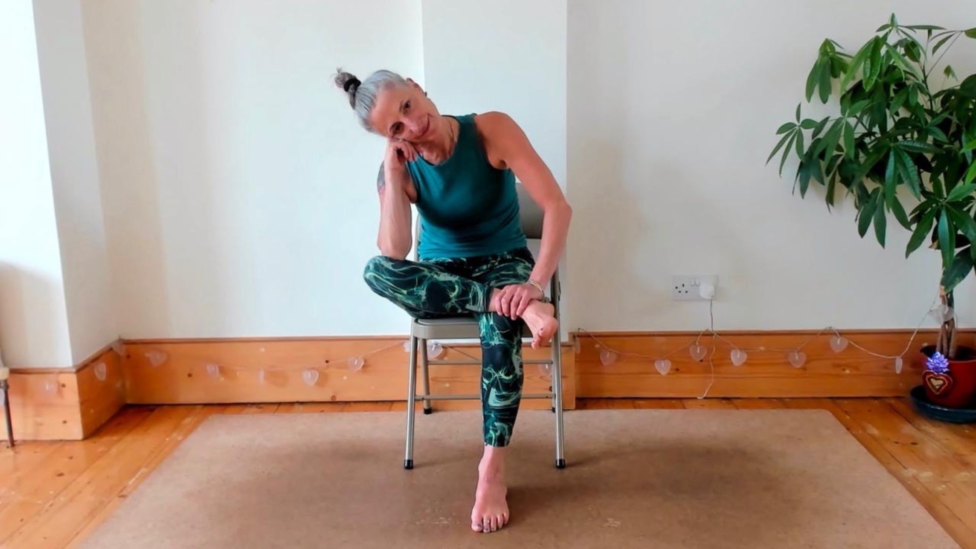 Dina Cohen demonstrates the seated pigeon pose