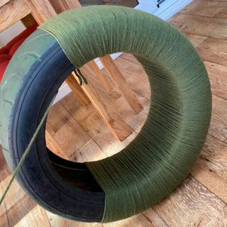 tyre with green string and chair
