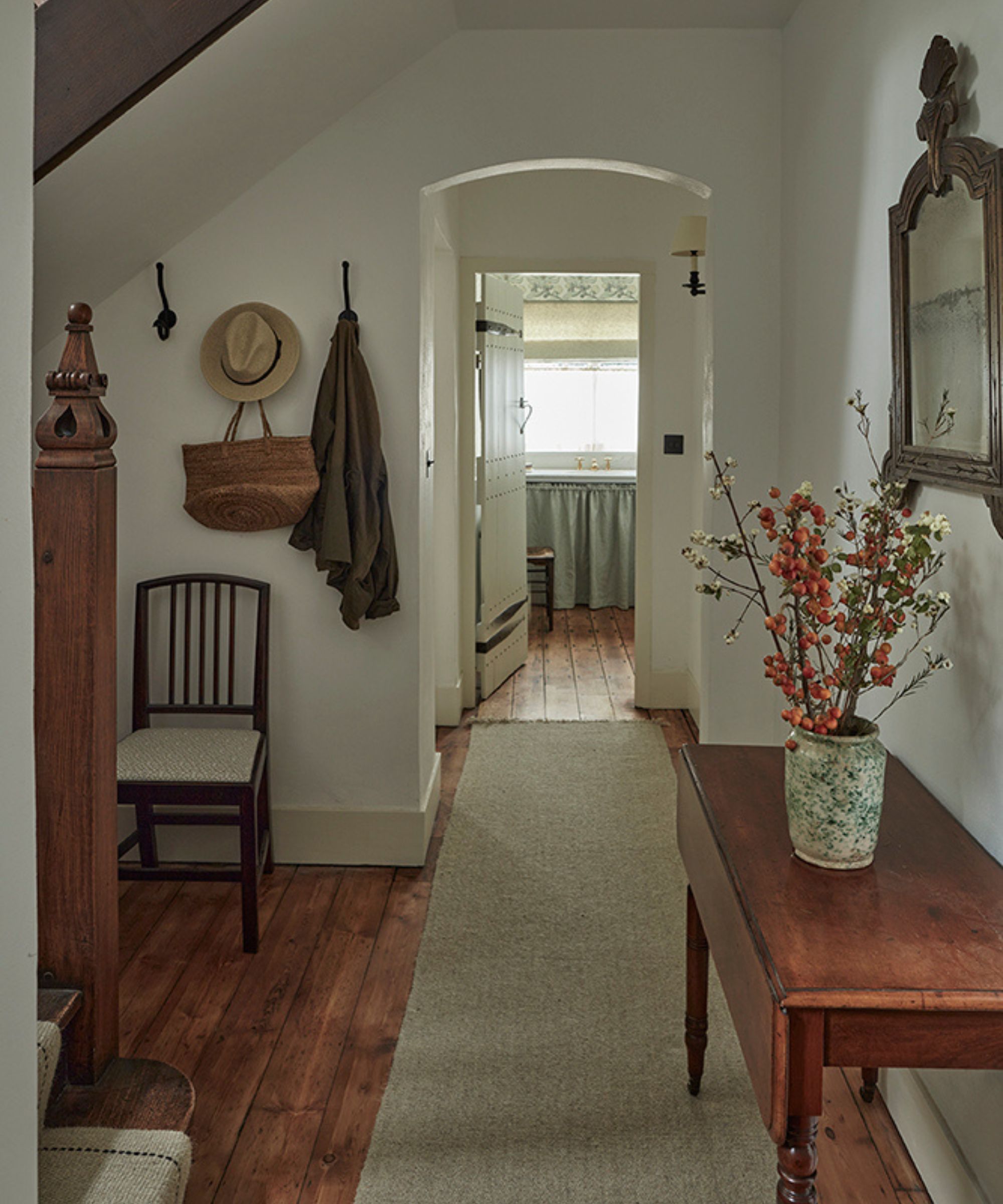 a small vintage styled neutral entryway in a cottage in Hampsted, London