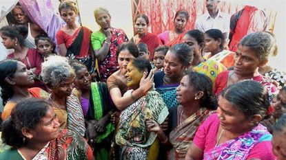 Mourners of the men who died from drinking toxic liquor.