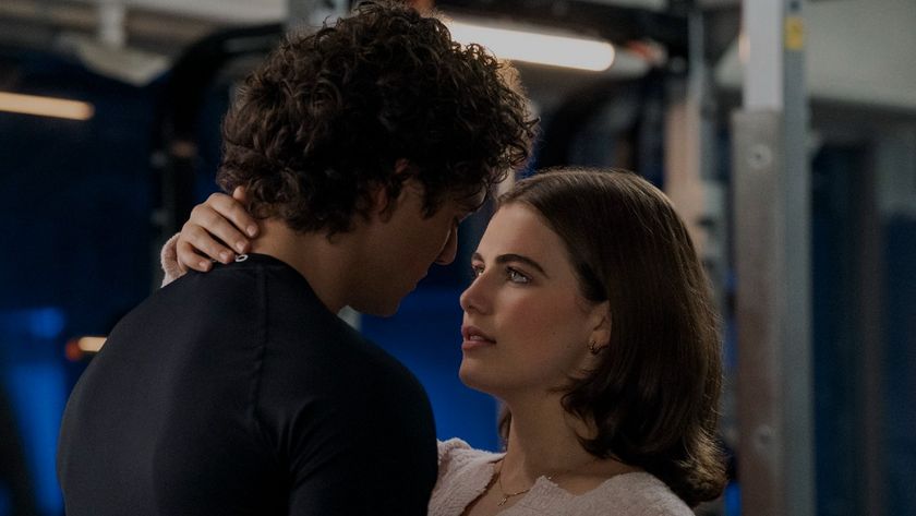 From left to right: Garrett (Belmont Cameli) looking down at Hannah (Ella Bright), and Hannah holding the back of Garrett's neck and looking up at him.