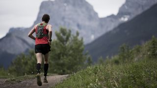 A man trail running in the mountains
