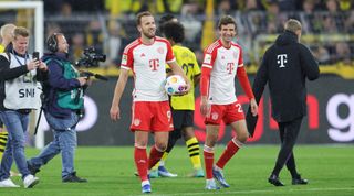 DORTMUND, GERMANY - NOVEMBER 4: Harry Kane of Bayern München celebrates with Thomas Müller of Bayern after the Bundesliga match between Borussia Dortmund and FC Bayern München at Signal Iduna Park on November 4, 2023 in Dortmund, Germany. (Photo by Jürgen Fromme - firo sportphoto/Getty Images)