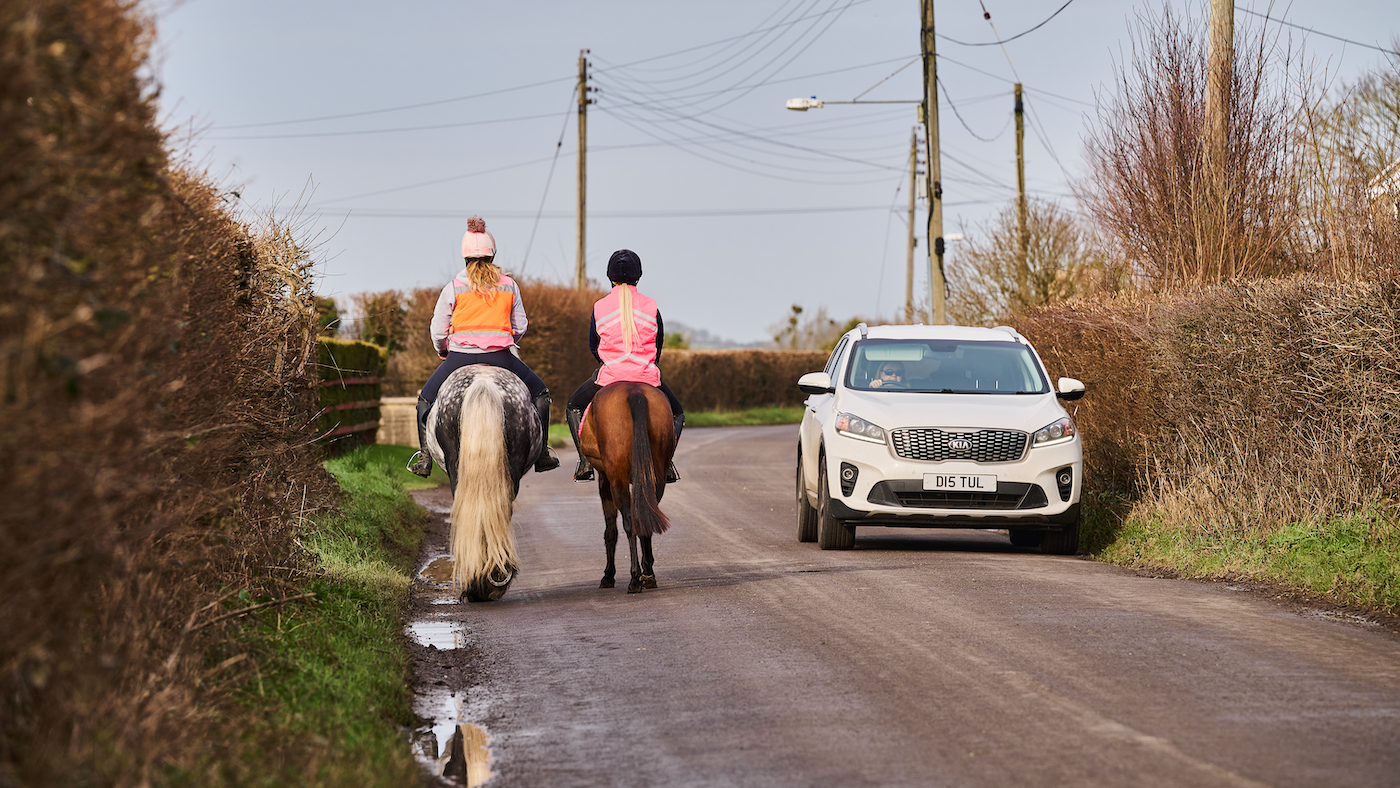 Confidence riding horse on the road