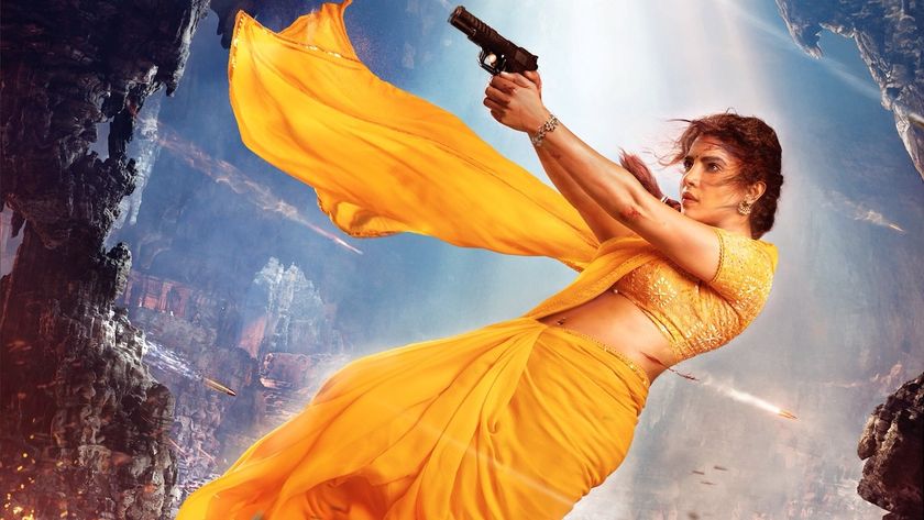 Priyanka Chopra wearing yellow sari as Mandakini and pointing a gun mid-air in Varanasi character poster