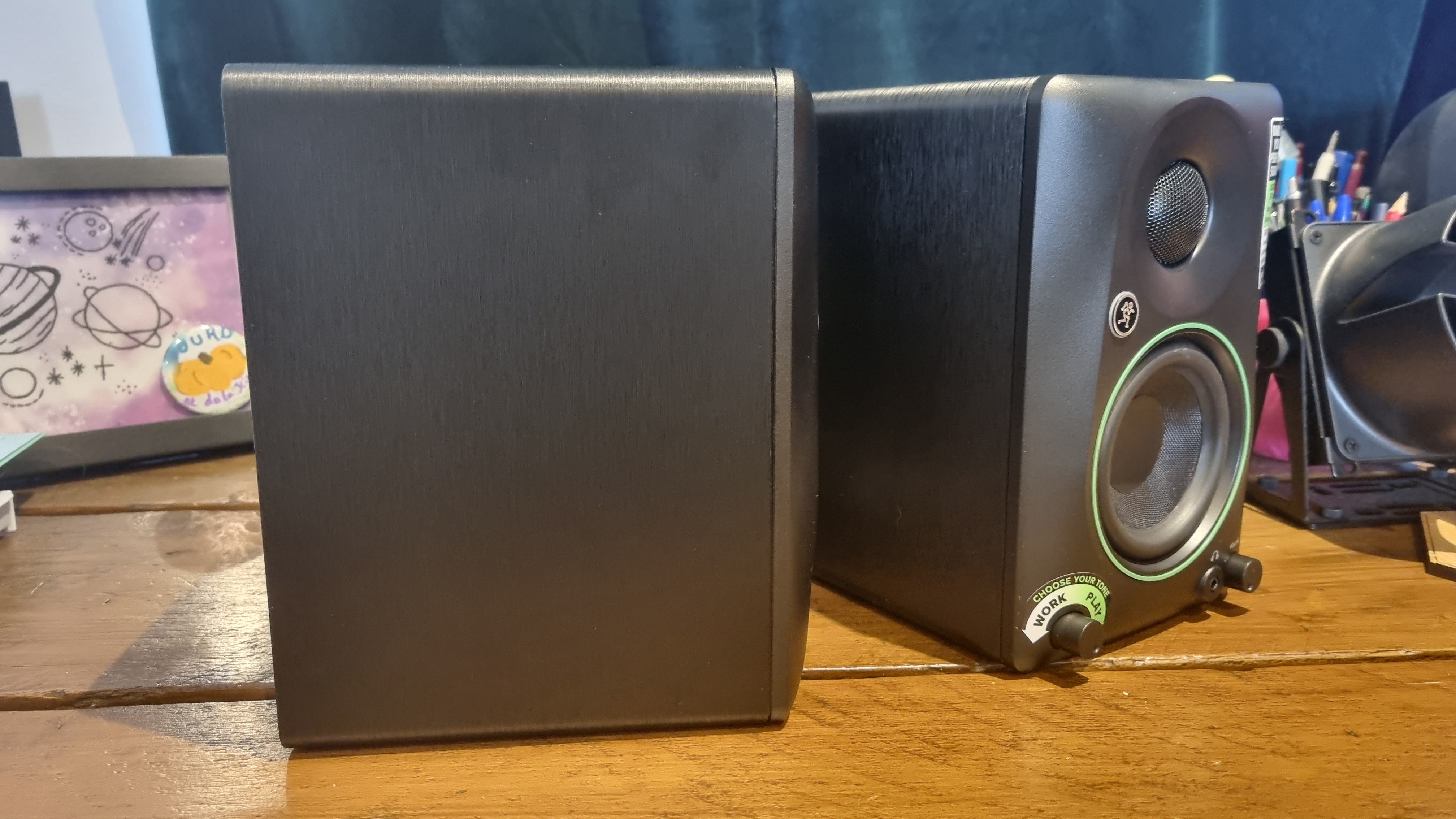 Two Mackie CR3.5 BT reference speakers, one turned in profile to show the depth