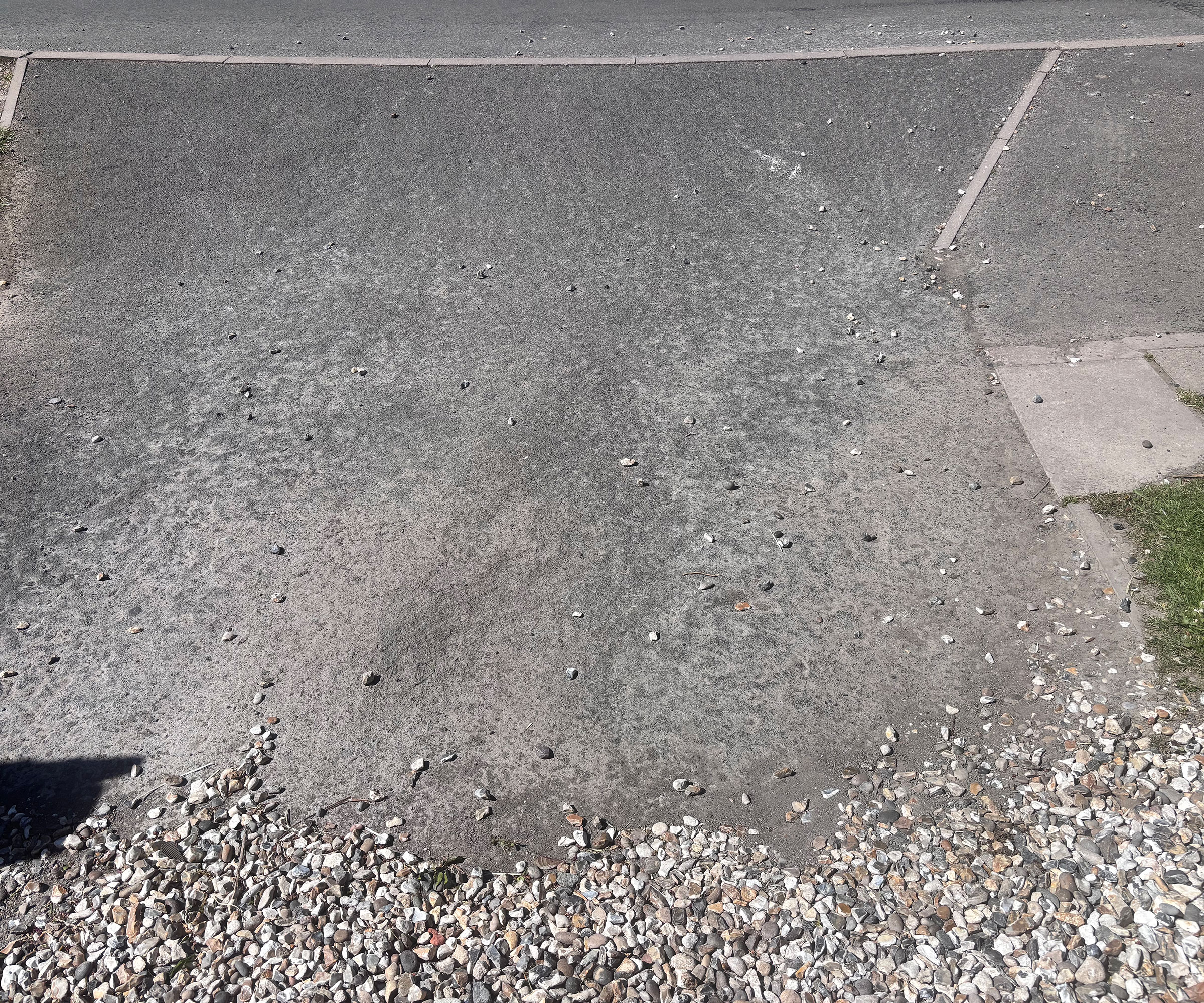 Sloping gravel driveway with gravel shifting