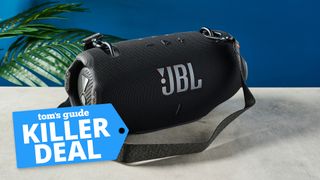 the jbl xtreme 4 photographed against a blue background with a tom's guide killer deal badge on the left