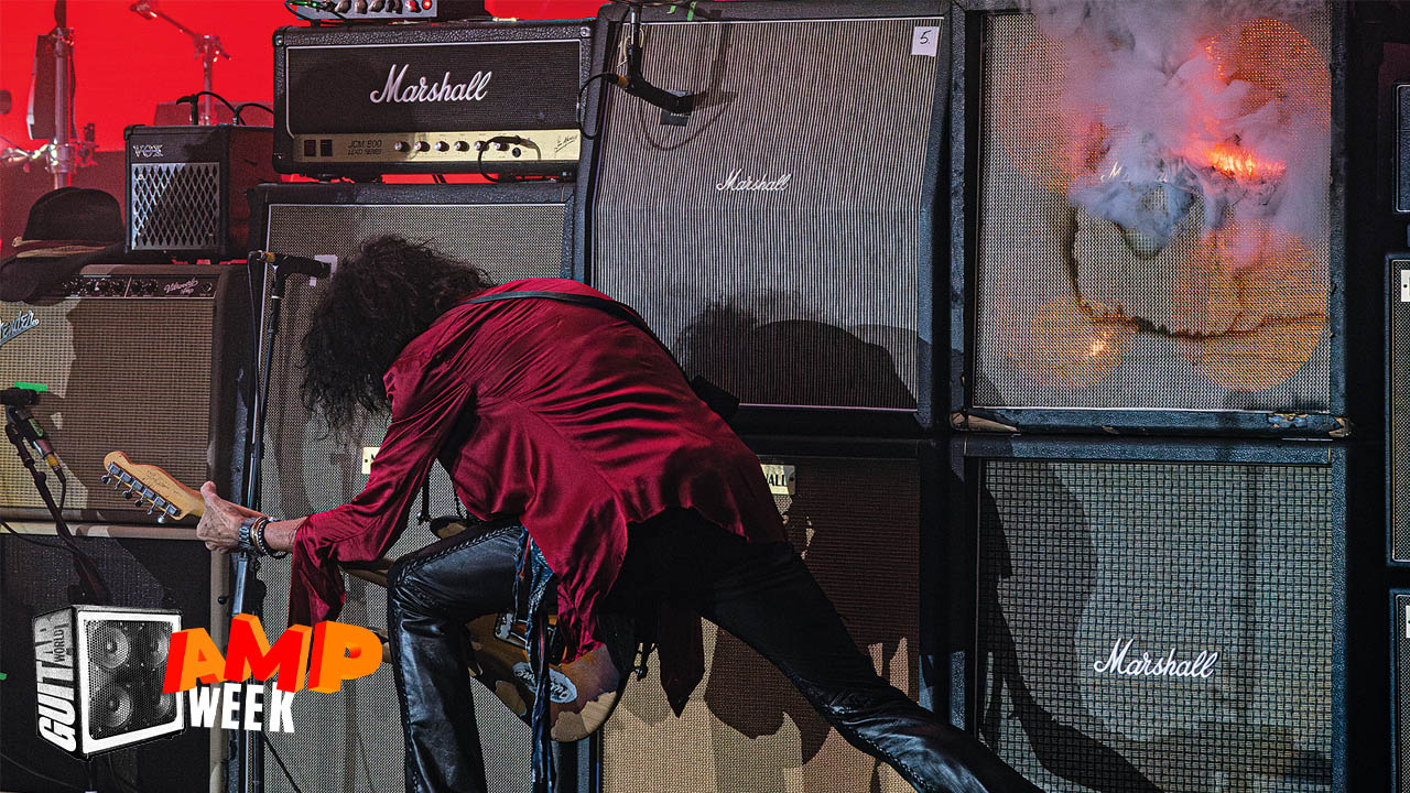 Joe Perry plays guitar in front of massive bank of Marshall amps