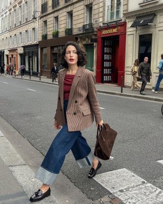 Influencer carries a brown bag.