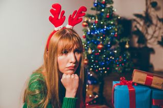 Young woman feeling sad during Christmas holiday