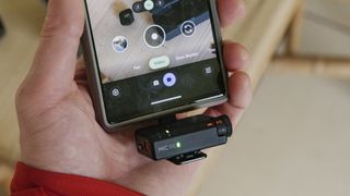 DJI Mic Mini receiver connected to a phone