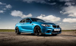 A side and front photo of the BMW M2.