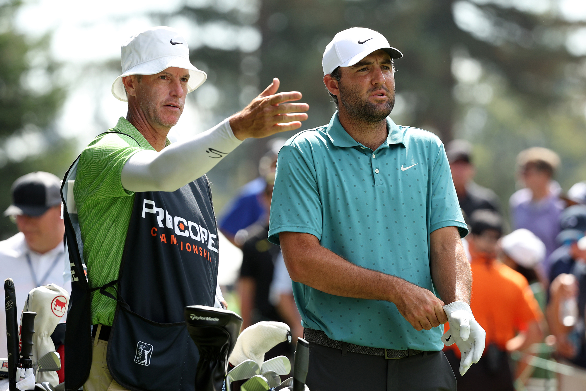 Scottie Scheffler with caddie Ted Scott at the Procore Championship on the PGA Tour, with Scott explaining something to Scheffler