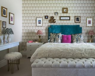 A teenage girl bedroom idea with palm print wallpaper, teal headboard and gallery walls