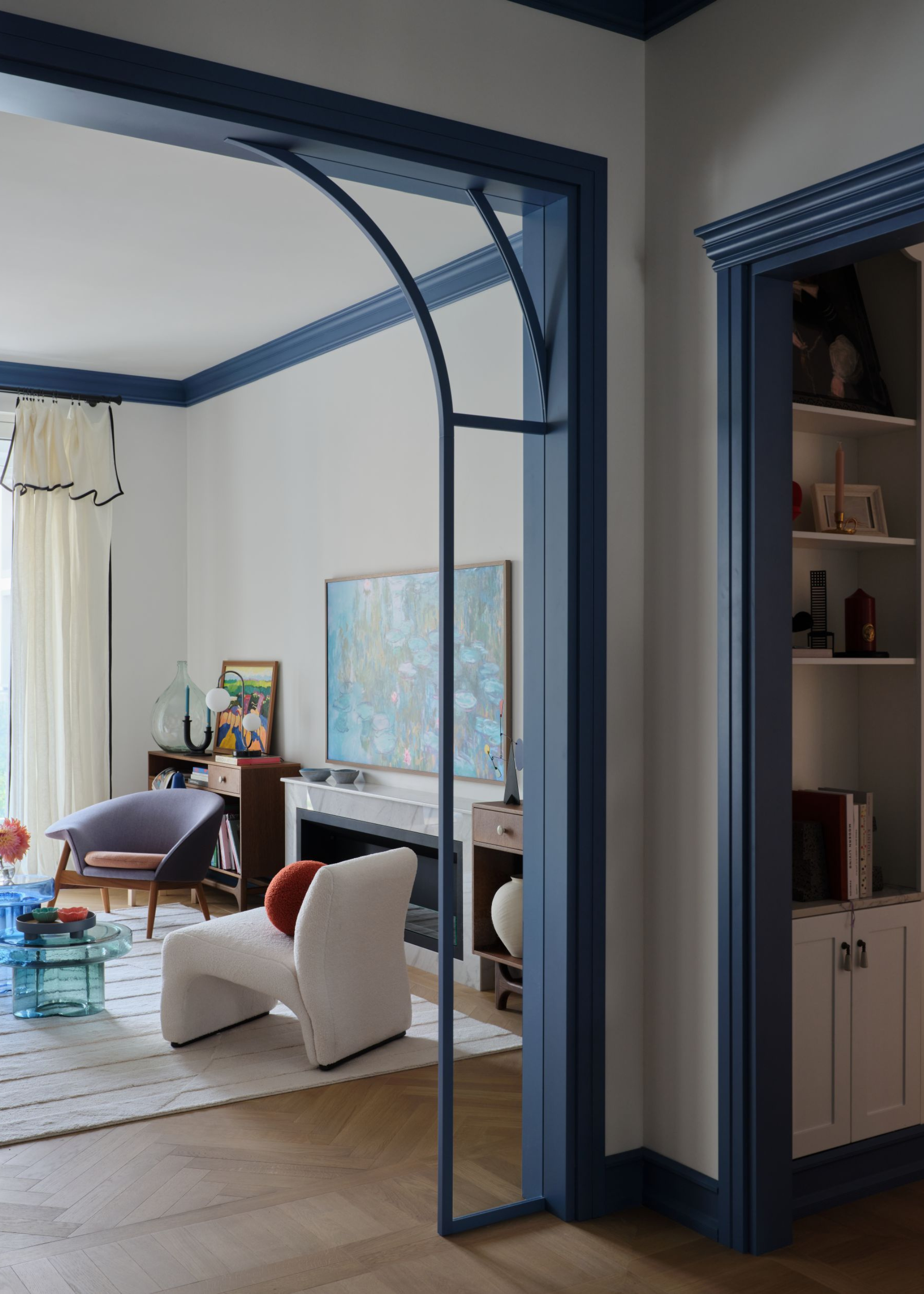 Open arched walkway with a blue trim in to a large living room