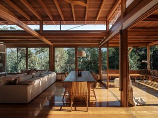 casa quinta by arquipelago, a wooden house on stilts above the rainforest canopy engulfed in greenery and open to nature